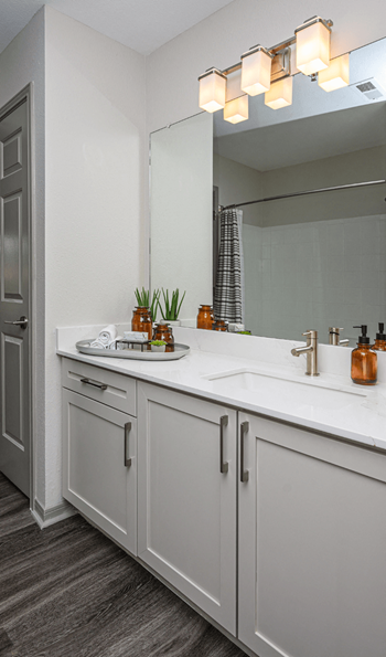 A white bathroom with two sinks and a mirror
